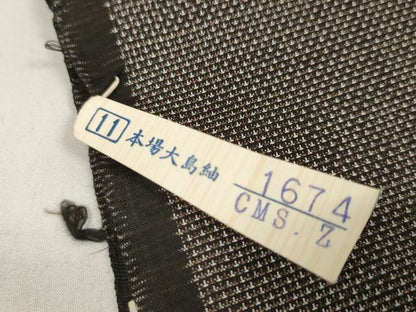 平和屋着物●本場大島紬　反物　着尺　9マルキ　古代染色純泥染　葡萄蔦の葉文　福留一男作　証紙付き　逸品　未使用　DAAV8417zzz